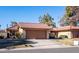 Tan stucco house with brown garage door and desert landscaping at 12234 S Shoshoni Dr, Phoenix, AZ 85044