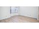 Bright living room featuring wood-look floors and a bay window at 12234 S Shoshoni Dr, Phoenix, AZ 85044