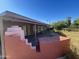 Back patio with built-in brick seating and covered area at 1324 W Bethany Home Rd, Phoenix, AZ 85013