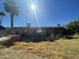 Backyard view of house with covered patio and palm trees at 1324 W Bethany Home Rd, Phoenix, AZ 85013