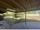 Covered patio with flagstone flooring and grassy yard at 1324 W Bethany Home Rd, Phoenix, AZ 85013