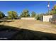 Large backyard with overgrown grass and storage shed at 1324 W Bethany Home Rd, Phoenix, AZ 85013