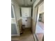 Functional laundry room with upper cabinets and wood paneling at 1324 W Bethany Home Rd, Phoenix, AZ 85013