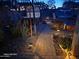 Paver pathway winding through landscaped backyard with night lighting and play area at 1340 S 232Nd Ave, Buckeye, AZ 85326