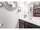 Bathroom with dark brown vanity and decorative mirrors at 1340 S 232Nd Ave, Buckeye, AZ 85326