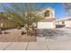 Two-story house with a white garage door and landscaping at 1340 S 232Nd Ave, Buckeye, AZ 85326