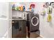 Laundry room with washer, dryer, and shelving at 1340 S 232Nd Ave, Buckeye, AZ 85326