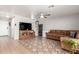 Living room with brown sectional sofa and tiled floors at 1340 S 232Nd Ave, Buckeye, AZ 85326