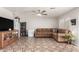 Living room with brown sectional sofa and tiled floors at 1340 S 232Nd Ave, Buckeye, AZ 85326