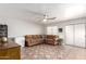 Living room with brown sectional sofa and tiled floors at 1340 S 232Nd Ave, Buckeye, AZ 85326