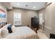 Intimate bedroom showcasing a rustic bed frame, bedside table and decorative shuttered windows at 1457 E Copper Holw, Queen Creek, AZ 85140
