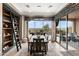 Dining room showcases a modern light fixture, view of outdoor pool, and sliding glass doors to the patio at 1457 E Copper Holw, Queen Creek, AZ 85140