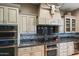 Kitchen features stainless steel appliances, neutral cabinets, modern hardware, and tiled backsplash at 1457 E Copper Holw, Queen Creek, AZ 85140