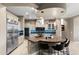This gorgeous kitchen boasts stainless steel appliances, a dark tiled backsplash, and a functional island at 1457 E Copper Holw, Queen Creek, AZ 85140