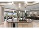 The kitchen features a large island, pendant lighting, sink and open view of the dining and living room at 1457 E Copper Holw, Queen Creek, AZ 85140