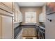Well-lit laundry room with a modern washer and dryer, ample cabinet space, and a sleek countertop at 1457 E Copper Holw, Queen Creek, AZ 85140