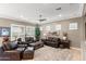 Relaxing living room with leather sofas, a coffee table, and large windows at 1457 E Copper Holw, Queen Creek, AZ 85140