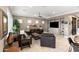 Neutral living room with tiled floors, modern ceiling fan, built-in shelves, and plenty of natural light at 1457 E Copper Holw, Queen Creek, AZ 85140