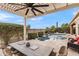 Covered patio with dining area and pool view at 1457 E Copper Holw, Queen Creek, AZ 85140