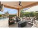 Covered patio with seating area and fire pit at 1457 E Copper Holw, Queen Creek, AZ 85140