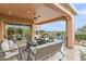 Relaxing patio with seating area, fire pit, and view of the pool at 1457 E Copper Holw, Queen Creek, AZ 85140