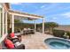 Covered patio with seating and a spa, ideal for outdoor dining at 1457 E Copper Holw, Queen Creek, AZ 85140