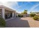 Covered patio, gravel yard, and mature landscaping at 15430 W Amelia Dr, Goodyear, AZ 85395