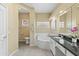 Elegant bathroom with a large soaking tub, double vanity, and granite countertops at 15430 W Amelia Dr, Goodyear, AZ 85395