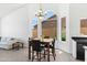 Bright breakfast nook with a glass-top table and four chairs, adjacent to a large window at 15430 W Amelia Dr, Goodyear, AZ 85395