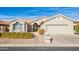 Single-story home with a two-car garage and well-manicured landscaping at 15430 W Amelia Dr, Goodyear, AZ 85395