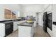 Modern kitchen featuring granite countertops, white cabinetry, and stainless steel appliances at 15430 W Amelia Dr, Goodyear, AZ 85395