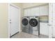 Convenient laundry room with washer, dryer, and additional storage at 15430 W Amelia Dr, Goodyear, AZ 85395