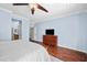 Relaxing bedroom with hardwood floors, a dresser, and a flat-screen TV at 1723 E Cotton Ct, Gilbert, AZ 85234