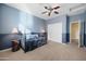 Bedroom with blue walls, ceiling fan, and a daybed at 1723 E Cotton Ct, Gilbert, AZ 85234