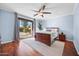 Serene bedroom with wood flooring, a ceiling fan and access to the backyard pool at 1723 E Cotton Ct, Gilbert, AZ 85234