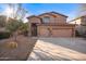 Two-story house with stone accents and a three-car garage at 1723 E Cotton Ct, Gilbert, AZ 85234