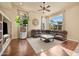 Spacious living room featuring a large leather sectional sofa, hardwood floors, and built-in shelving at 1723 E Cotton Ct, Gilbert, AZ 85234