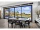 Modern dining room with large sliding glass doors and views of pool and golf course at 17444 N 79Th St, Scottsdale, AZ 85255