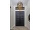 Grand entryway featuring a striking light fixture and black doors at 17444 N 79Th St, Scottsdale, AZ 85255