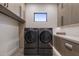 Bright laundry room with modern washer and dryer, and ample storage at 17444 N 79Th St, Scottsdale, AZ 85255