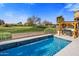 Inviting pool area with a built-in barbecue and golf course views at 17444 N 79Th St, Scottsdale, AZ 85255