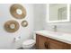 Modern bathroom with a floating vanity, lighted mirror, and decorative mirrors at 17925 W Mauna Loa Ln, Surprise, AZ 85388