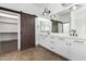 Elegant bathroom with double vanity and barn door at 17925 W Mauna Loa Ln, Surprise, AZ 85388