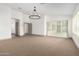 Bright bedroom featuring sliding glass doors and carpeting at 17925 W Mauna Loa Ln, Surprise, AZ 85388