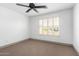 Bright bedroom with carpet flooring and window shutters at 17925 W Mauna Loa Ln, Surprise, AZ 85388