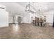 Bright dining room featuring a large chandelier and tile flooring at 17925 W Mauna Loa Ln, Surprise, AZ 85388