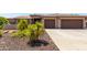 Two-story house with a three-car garage and landscaped front yard at 17925 W Mauna Loa Ln, Surprise, AZ 85388