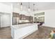 Modern kitchen with stainless steel appliances and a large island with white countertops at 17925 W Mauna Loa Ln, Surprise, AZ 85388