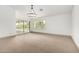 Light-filled living room with sliding doors and carpeting at 17925 W Mauna Loa Ln, Surprise, AZ 85388