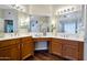 Double vanity bathroom with wood cabinets and a large mirror at 1931 W Mulberry Dr, Chandler, AZ 85286